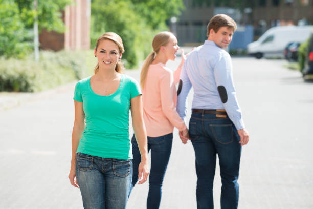 Young Happy Woman Walking On Street Woman Shouting At Her Boyfriend Looking At Woman Walking On Street former photos stock pictures, royalty-free photos & images