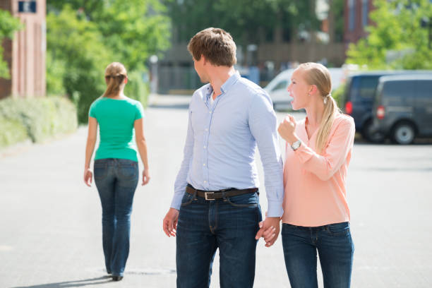 Woman Shouting At Her Boyfriend Looking At Another Woman Young Woman Shouting At Her Boyfriend Looking At Another Woman On Street former stock pictures, royalty-free photos & images