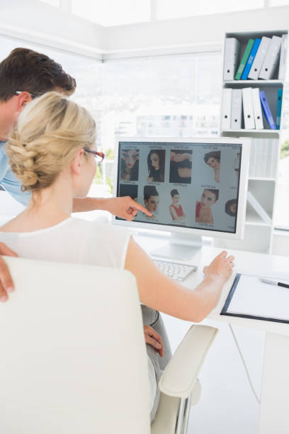 istock Rear view of photo editors working on computer 833530792