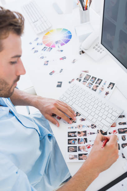 istock Male photo editor at work in the office 833533182