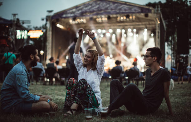 istock Friends sitting on the grass and having fun 833533496
