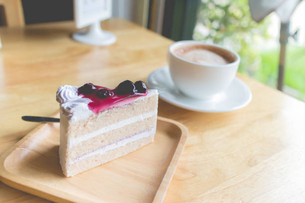 istock blueberry cake and hot coffee mocha with foam milk 833533714