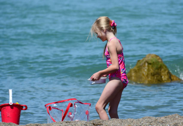 istock A Young Girl Plays at the Beach 833551110