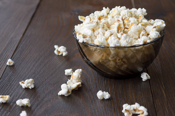 istock Salty popcorn on the wooden table 833578802