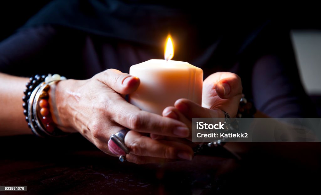 hands holding a candle female hands holding a burning candle Burning Stock Photo