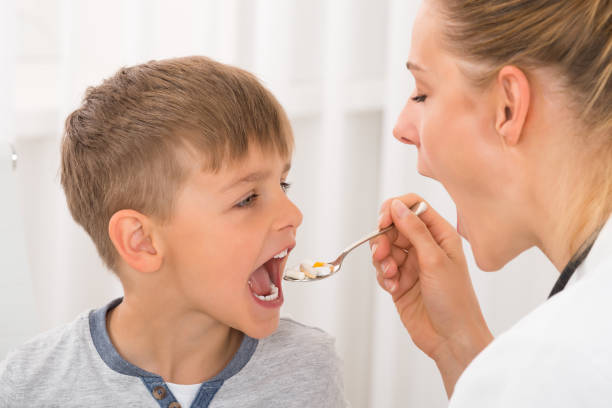 istock Doctor Giving Medicine To Boy 833607198