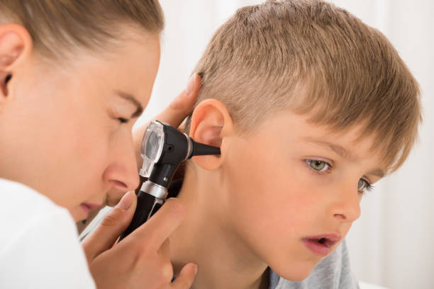 istock Doctor Examining Boy's Ear 833608132