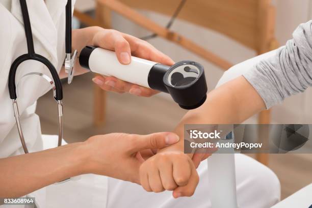 Doctor Examining Skin Of Child Patient Stock Photo - Download Image Now - Dermatology, Child, Skin