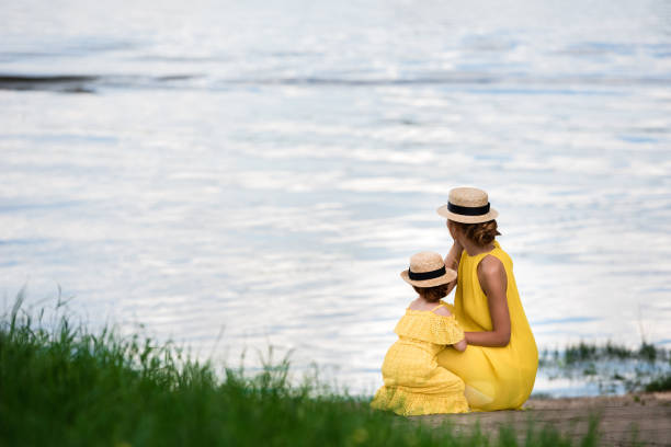istock mother and daughter at riverside 833613200