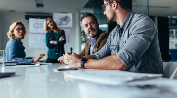 istock Businessman explaining new business ideas to peers 833628910