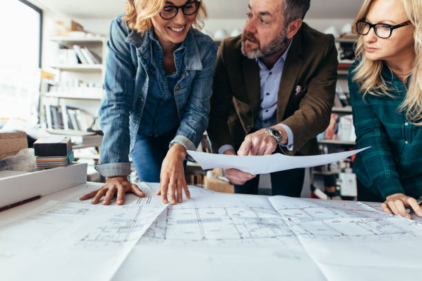 istock Business people discussing over construction plan 833629028