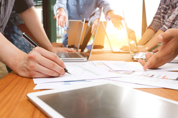 istock business team meeting to discuss business project document 833632458