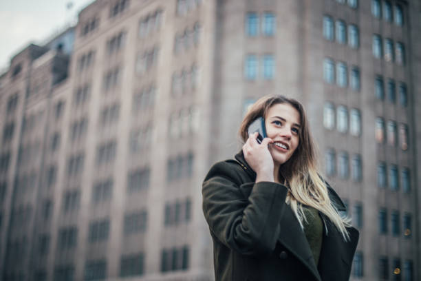 istock Beautiful young woman talking on smartphone 833634336