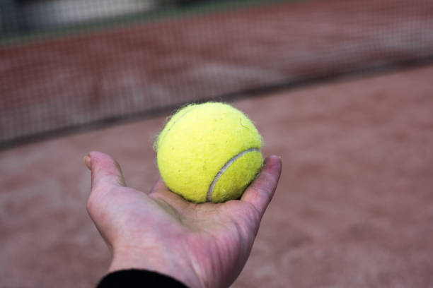 istock Tennis ball in a hand 833646868