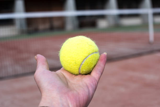 istock Tennis ball in a hand 833647568