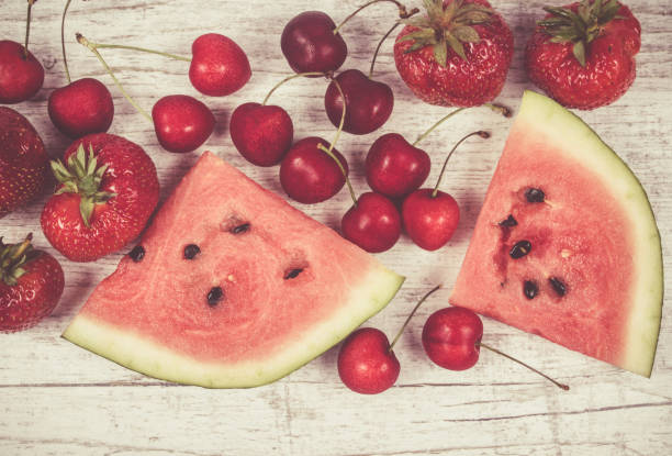 istock Watermelon, strawberries and cherries on wooden background. 833665336