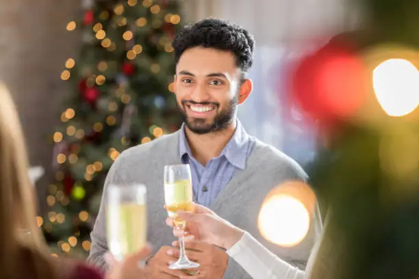 Photo of Young man receives toast during Christmas celebration
