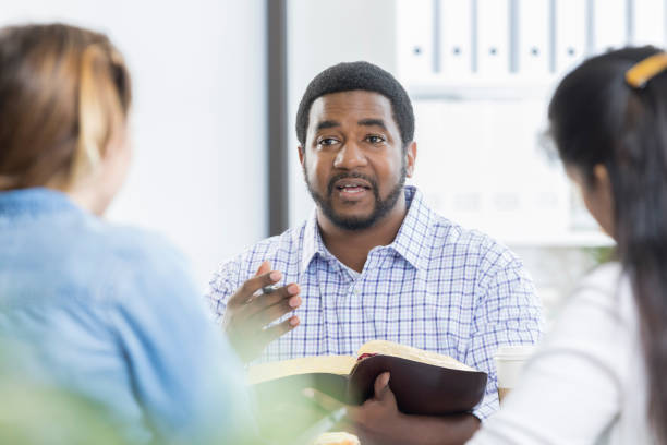 istock Confident businessman facilitates office Bible study 833666974