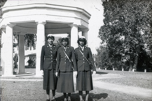 Washington D.C., USA, 1951. Three African American traffic wardens in a park in Washington DC. In the background is a pavilion. On the upper ledge is the word \