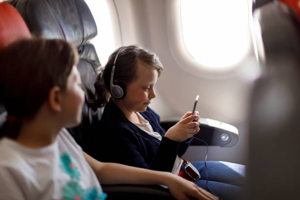 istock Happy kids travelling in plane 833697898