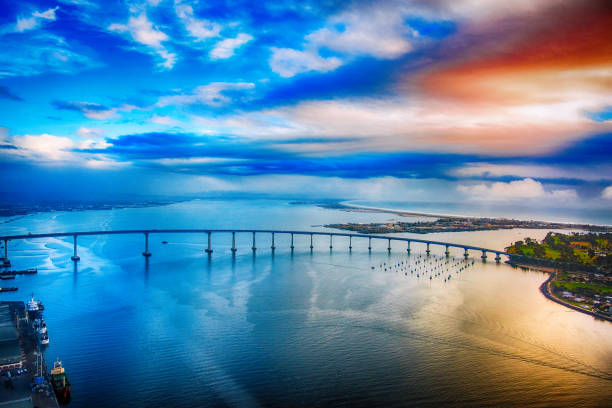 Aerial view of the San Diego Bay and full span of the Coronado Bridge shot from an altitude of about 1000 feet over downtown San Diego at dusk after a storm had cleared.