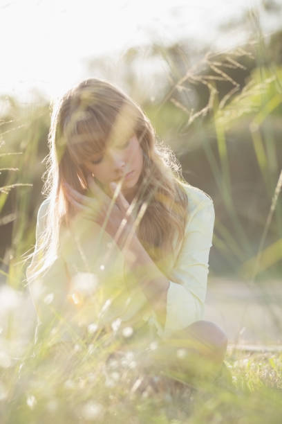 istock Blonde hipster girl sitting on the grass 833722490