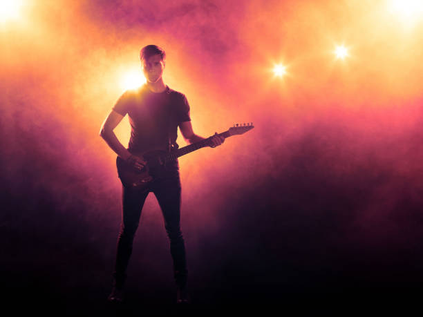 istock Silhouette of guitar player on stage 833735702