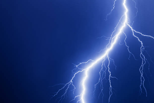 istock Lightning strike bolt in night dark blue sky. 833736118