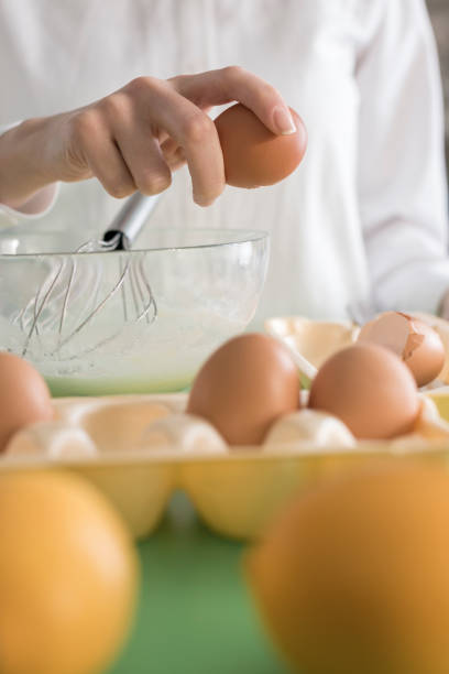 istock Close-up, woman hand putting egg in bowl 833747510