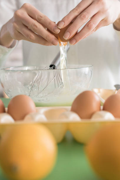 istock Close-up, woman hand putting egg in bowl 833747566