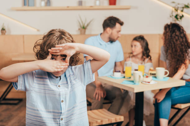 istock boy in cafe making frame of hands 833752360