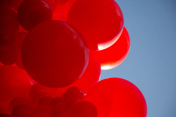 istock Red balloons blue sky background fun decoration 833757362