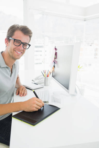 istock Side view of a casual male photo editor using graphics tablet 833758022