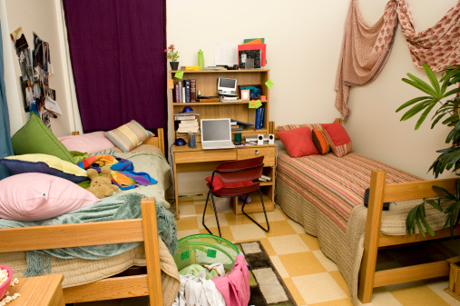 still life of dorm room showing neat side and messy side