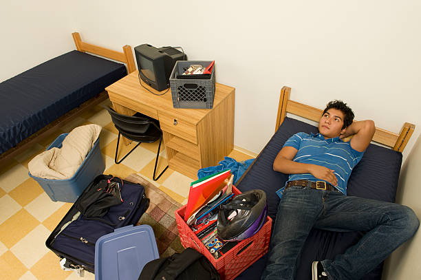 college student moving into dorm room - child lying on back setting the table clothing 뉴스 사진 이미지