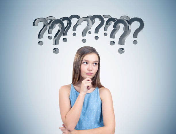 istock Pensive woman in a blue dress, question marks 833768030