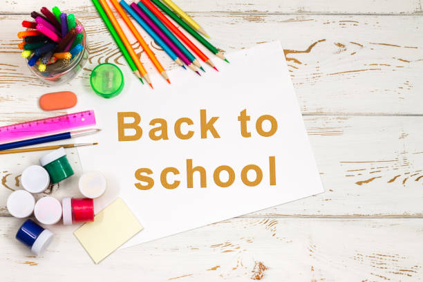 istock School supplies on a white wooden background with an empty space for inscriptions. 833768338
