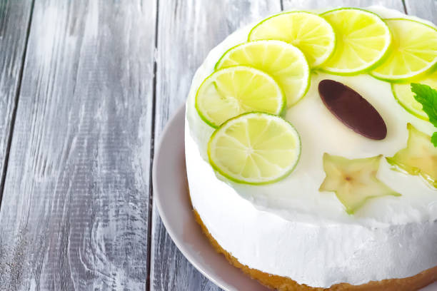 istock sweet white buttercream round cake with sliced lime on top 833771680