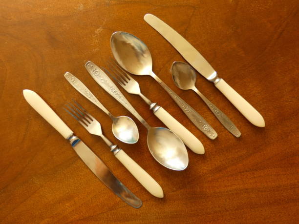 istock Cutlery (Spoons, Forks and Knives) On Wooden Table 833778706