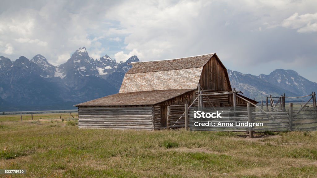 Moulton barn located in Mormon Row, Gros Ventre River Valley in Grand Teton National Park and active cloudy sky in background Barn Stock Photo