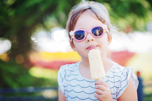 istock Young girl eating ice-cream in summer 833789228