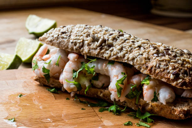 istock Shrimp Sandwich with lime on wooden surface. 833795500