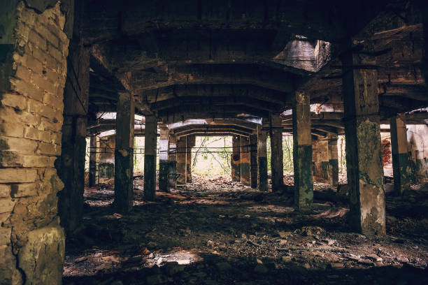 istock Empty ruined hall of abandoned warehouse 833804248