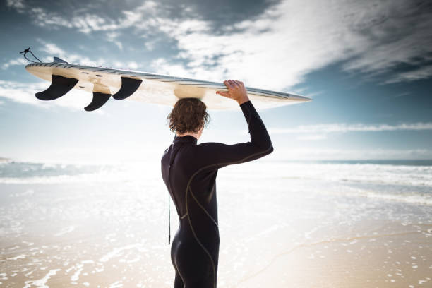 istock surfer walking in surfers paradise beach in australia 833804618