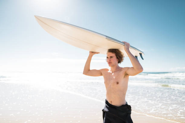 istock surfer walking in surfers paradise beach in australia 833804758