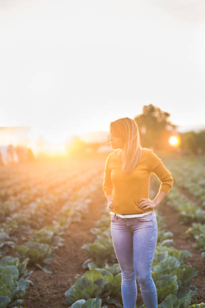 istock Young female farmer standing in her garden 833804822