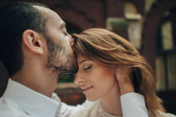 istock beautiful wedding couple hugging standing near old building 833826198