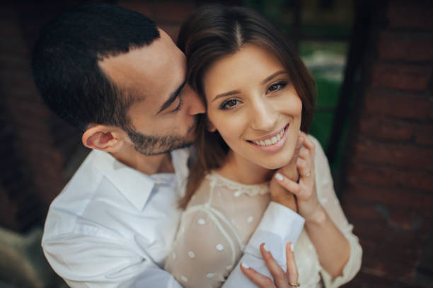 istock beautiful wedding couple hugging standing near old building 833826230