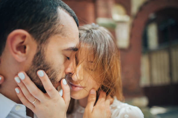 istock beautiful wedding couple hugging standing near old building 833828360