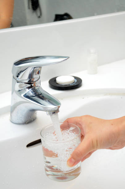 istock Filling a glass with water under the tap 833839964